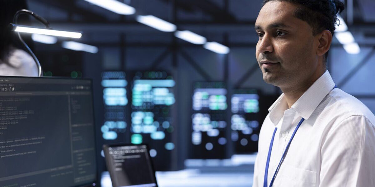 Specialist doing server racks maintenance using PC