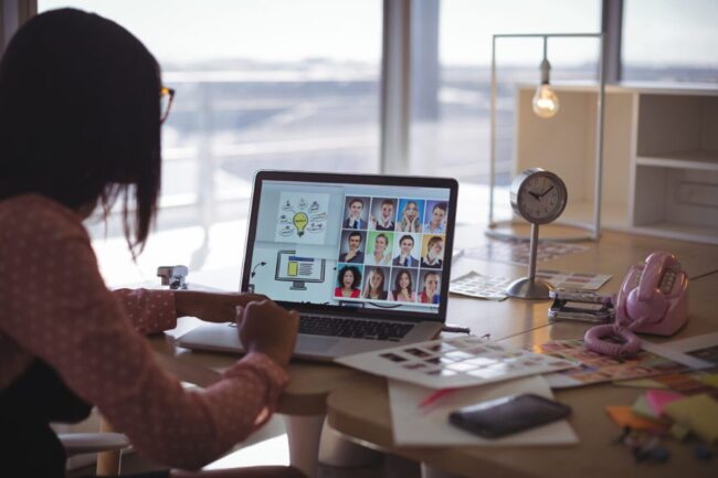 Businesswoman working on laptop at office desk remote office solutions